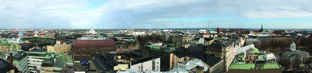 Click on picture - Helsinki skyline towards north and east. To the left of centr the green dome at the white Helsinki cathedral on the Senate square.  Photo: Odd Iglebaek